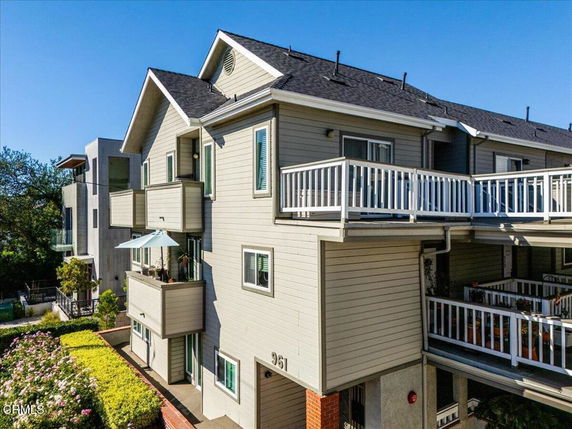 Front view of a multi-story residential building with balconies.