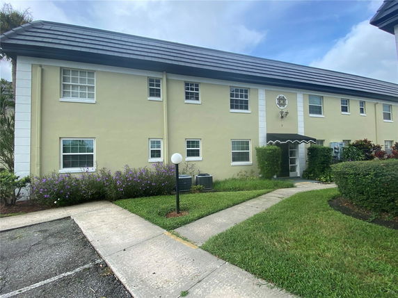 Front view of a two-story building with a central entrance and multiple windows.
