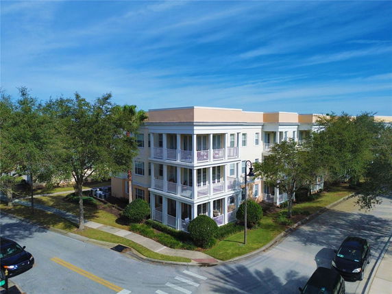 Front view of a three-story apartment building with balconies.