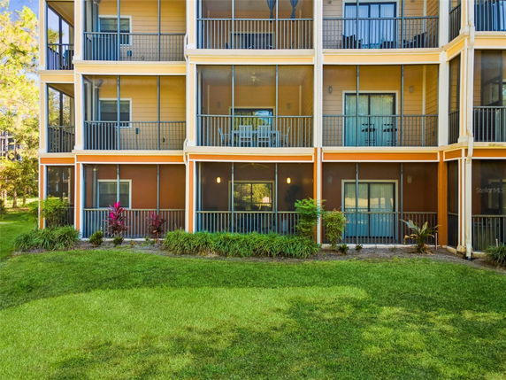 Front view of a multi-story building with balconies and screened porches.