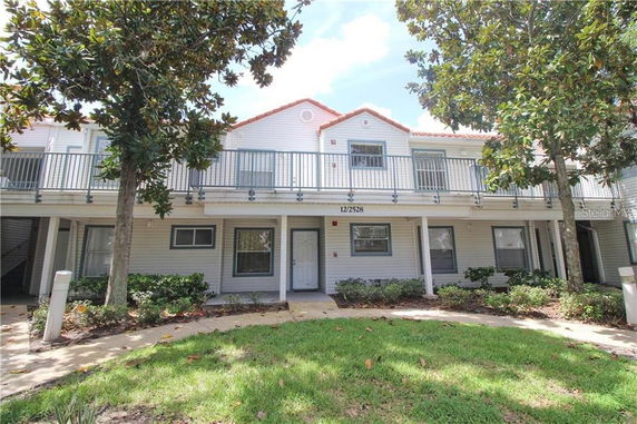 Front view of a two-story house with a balcony.