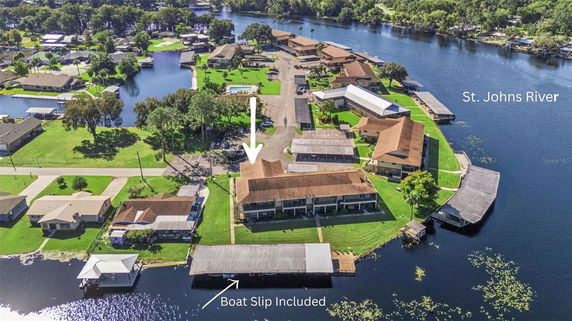 Panoramic view of residential buildings by the St. Johns River with boat slips included.