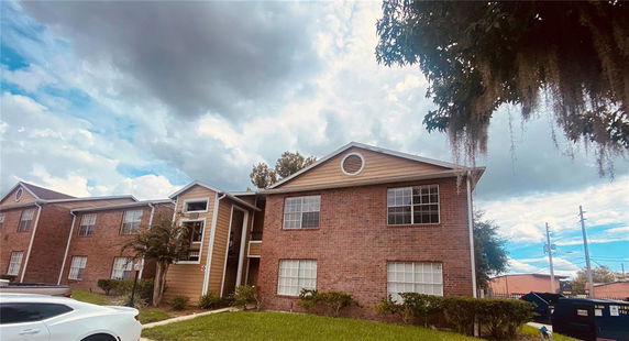Front view of a two-story brick apartment building.
