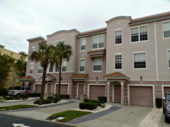 Front view of a multi-story residential building with attached garages.