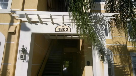 Front view of a multi-story building entrance with number 4802 displayed.