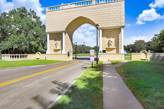Front view of a large archway entrance structure with statues.