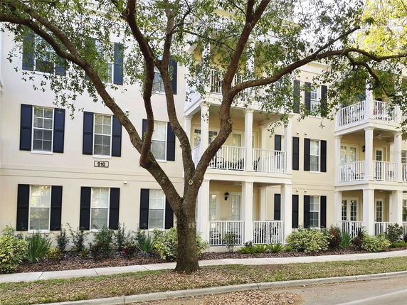 Front view of a residential building with balconies and multiple windows.