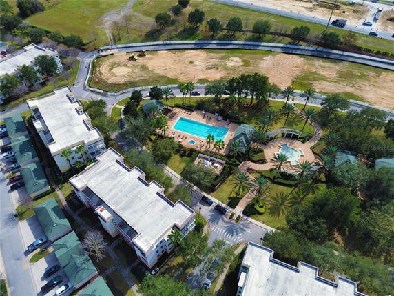 Aerial view of a residential complex with a swimming pool and landscaped area.