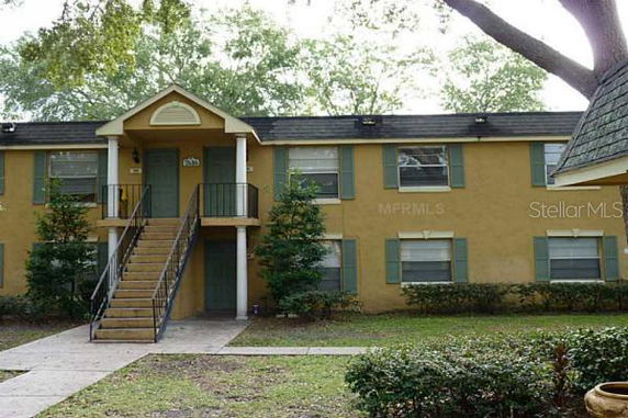 Front view of a two-story apartment building with exterior stairs.