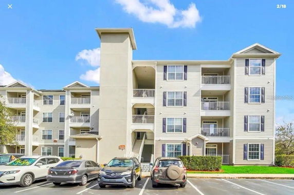 Front view of a multi-story apartment building with balconies.