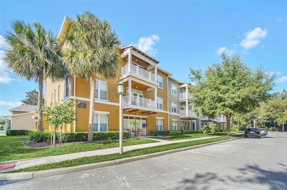 Front view of a multi-story residential building with balconies.