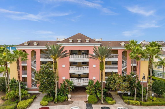 Front view of a multi-story building with a symmetrical design and balconies.