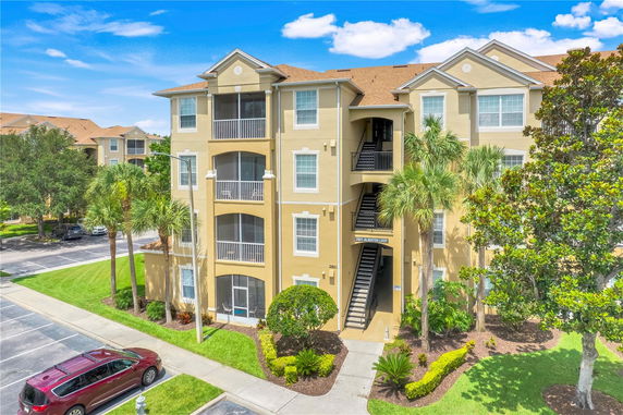 Front view of a multi-story apartment building with balconies.