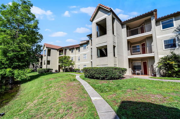 Front view of a three-story apartment building with balconies.