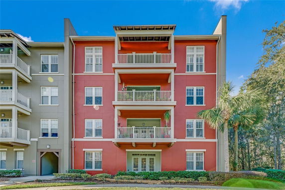 Front view of a multi-story apartment building with balconies.