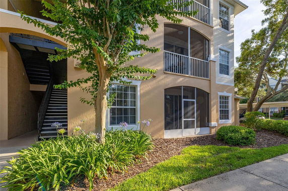 Front view of a multi-story building with balconies and a stairwell.