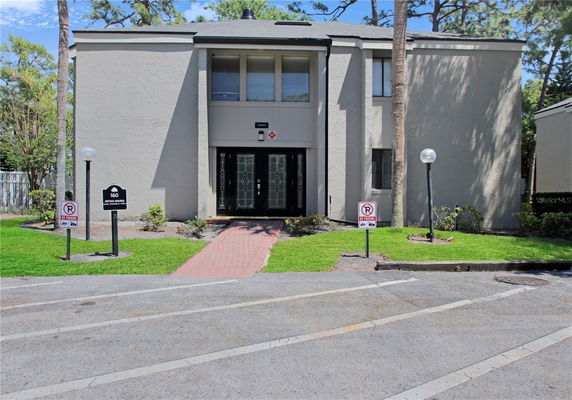 Front view of a two-story building with double entrance doors.