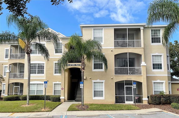 Front view of a multi-story apartment building with balconies.