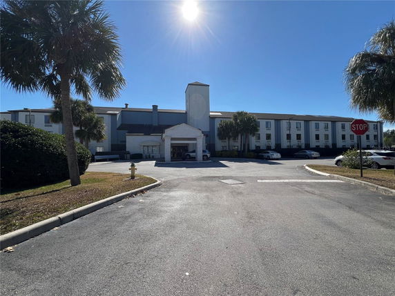 Front view of a three-story building with a covered entrance.