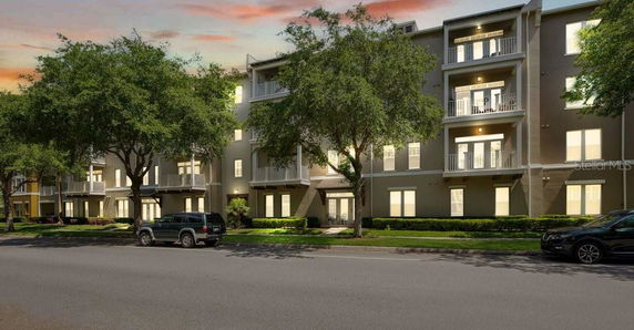 Front view of a multi-story apartment building with balconies.