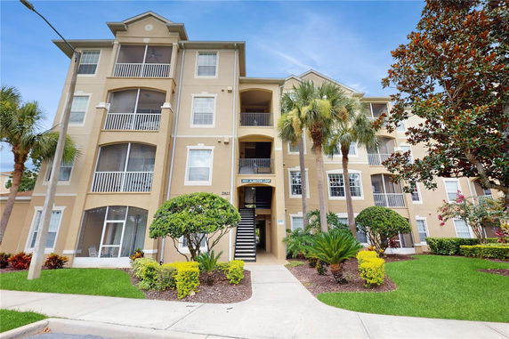 Front view of a multi-story apartment building with balconies.
