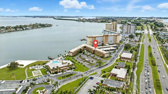 Aerial view of water bodies and buildings in a coastal area.