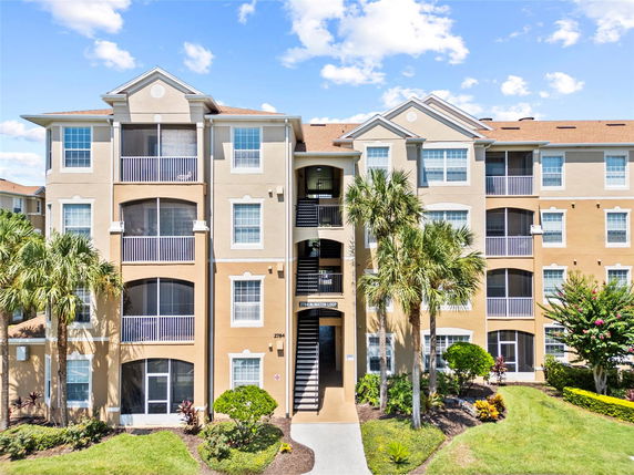 Front view of a multi-story apartment building with balconies.