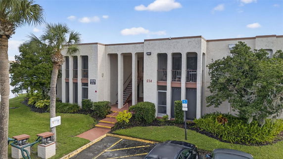 Front view of a two-story building with a central staircase and tall windows.