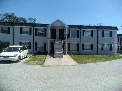 Front view of a two-story apartment building with a central staircase.