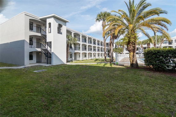 Front view of a multi-story building with external staircases and balconies.