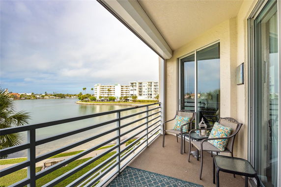 Balcony view of waterfront and apartment buildings.