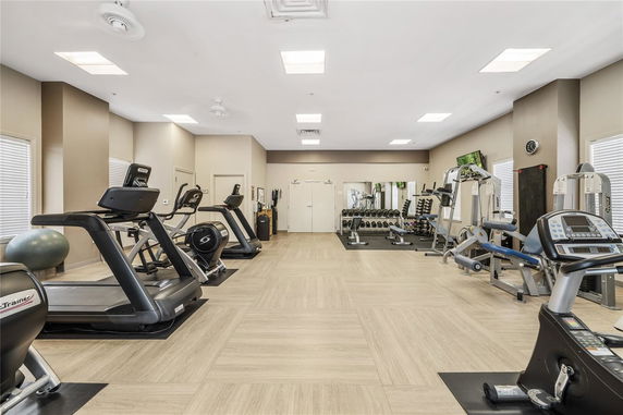 Interior view of a fitness room with exercise equipment and treadmills.