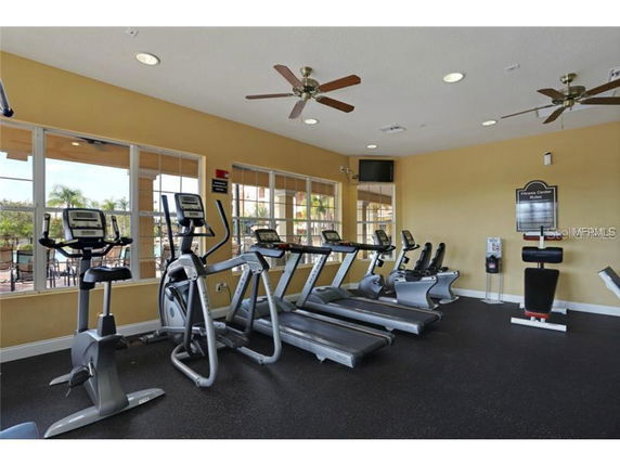 Indoor gym area with exercise equipment in a clubhouse.