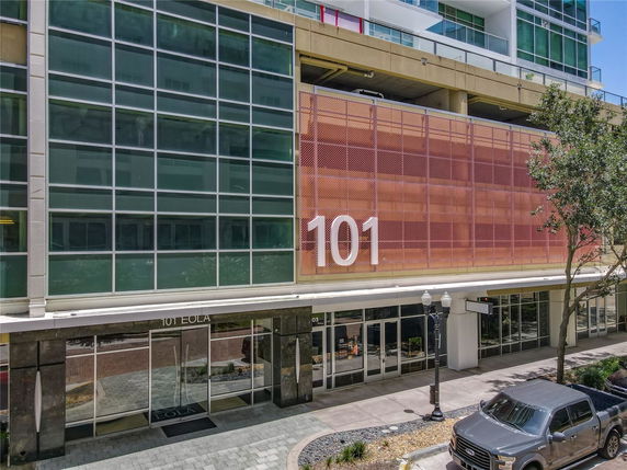 Front view of a modern building with large glass windows and the number 101 prominently displayed.