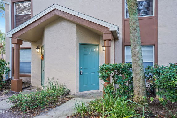 Front view of a house entrance with a blue door and small porch.