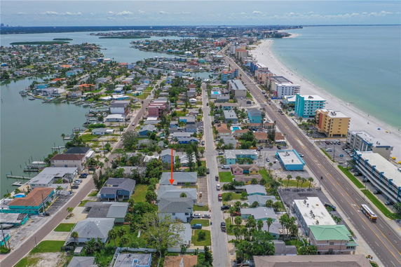 Aerial panoramic view of a coastal residential area and beach.