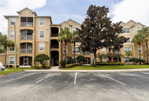 Front view of a multi-story apartment building with balconies.