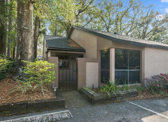 Front view of a single-story house with a gated entrance.