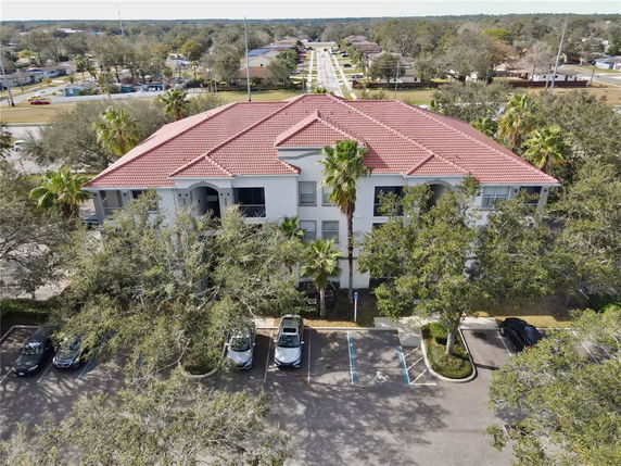 Front view of a large two-story building with a red tiled roof.