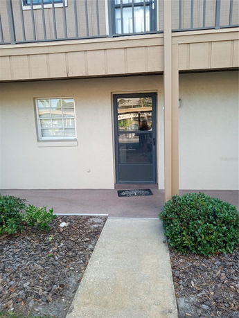 Front view of a two-story building with a door and a window at the ground level.