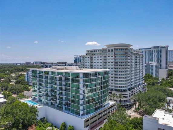 Front view of a modern multi-story residential building with glass balconies.