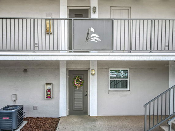 Exterior view of a two-story building with gray doors and railings.