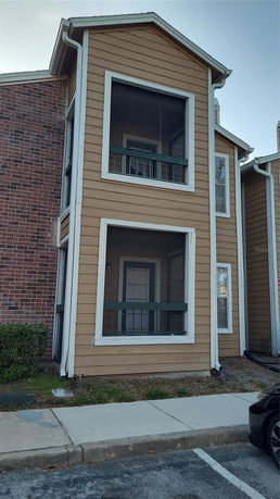 Front view of a two-story building with screened balconies.