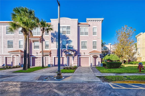 Front view of a multi-story residential building with garages.
