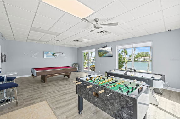 Indoor recreational area with a pool table, foosball, and air hockey.