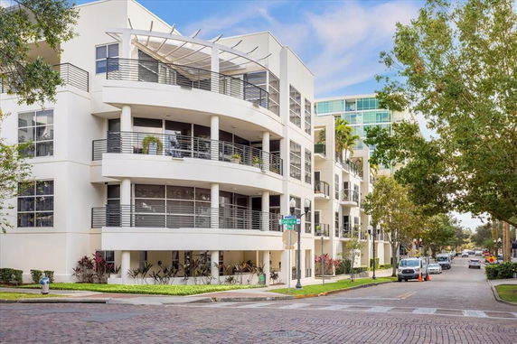 Front view of a multi-story modern apartment building with balconies.
