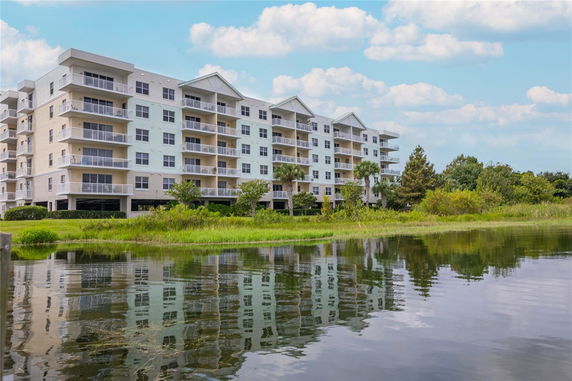 Front view of a multi-story apartment building with balconies.