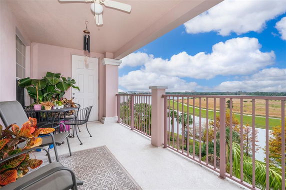 View from a balcony overlooking a landscape with a railing and surrounding greenery.