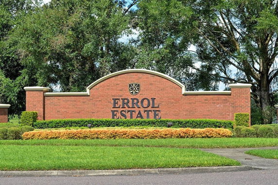 Front view of Errol Estate entrance sign made of red brick with landscaping.