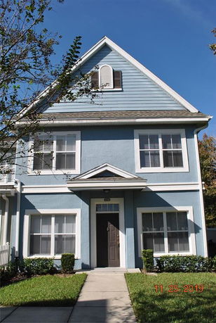 Front view of a two-story house with a blue exterior and a gable roof.